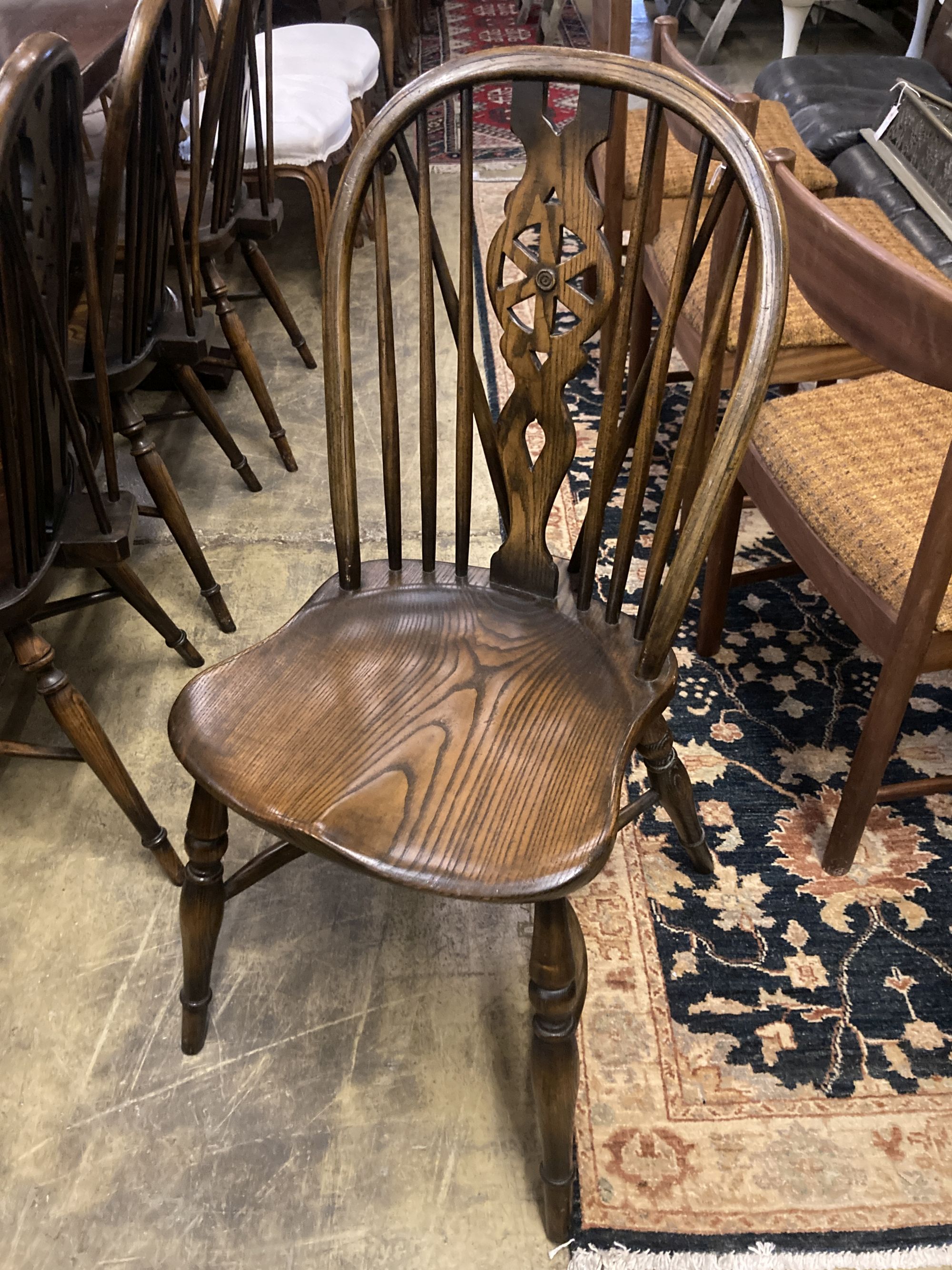 A set of ten stained ash and elm Windsor chairs with crinoline stretchers (two having arms)